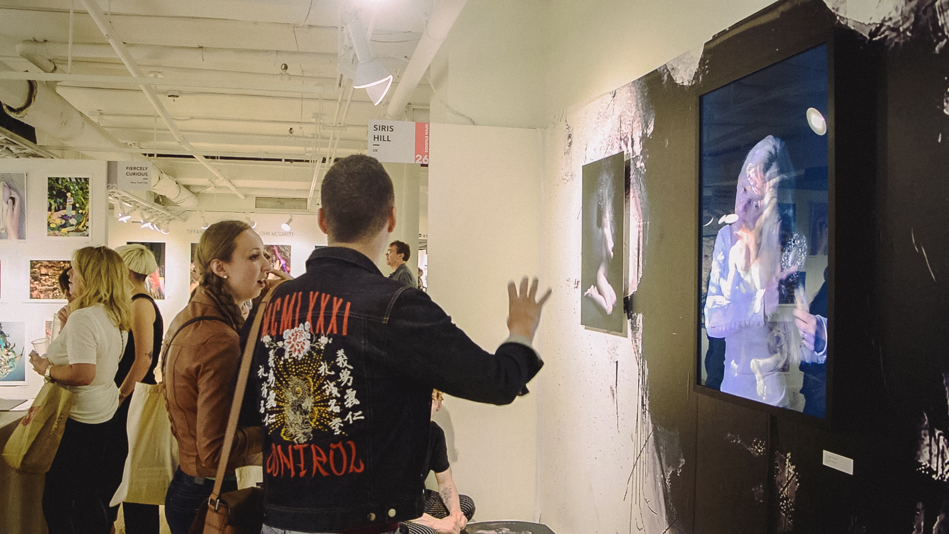 A visitor viewing a light-box work at the Siris Hill stand