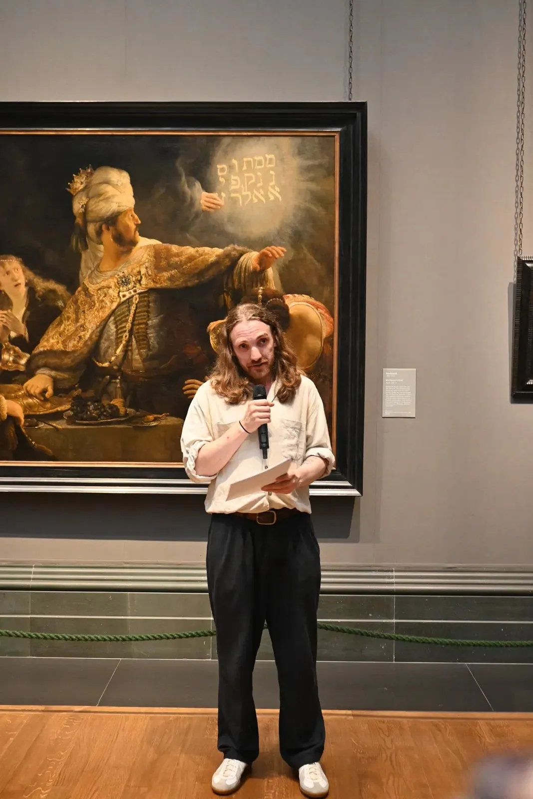 Siris Hill speaking before Rembrandt’s Belshazzar’s Feast, National Gallery