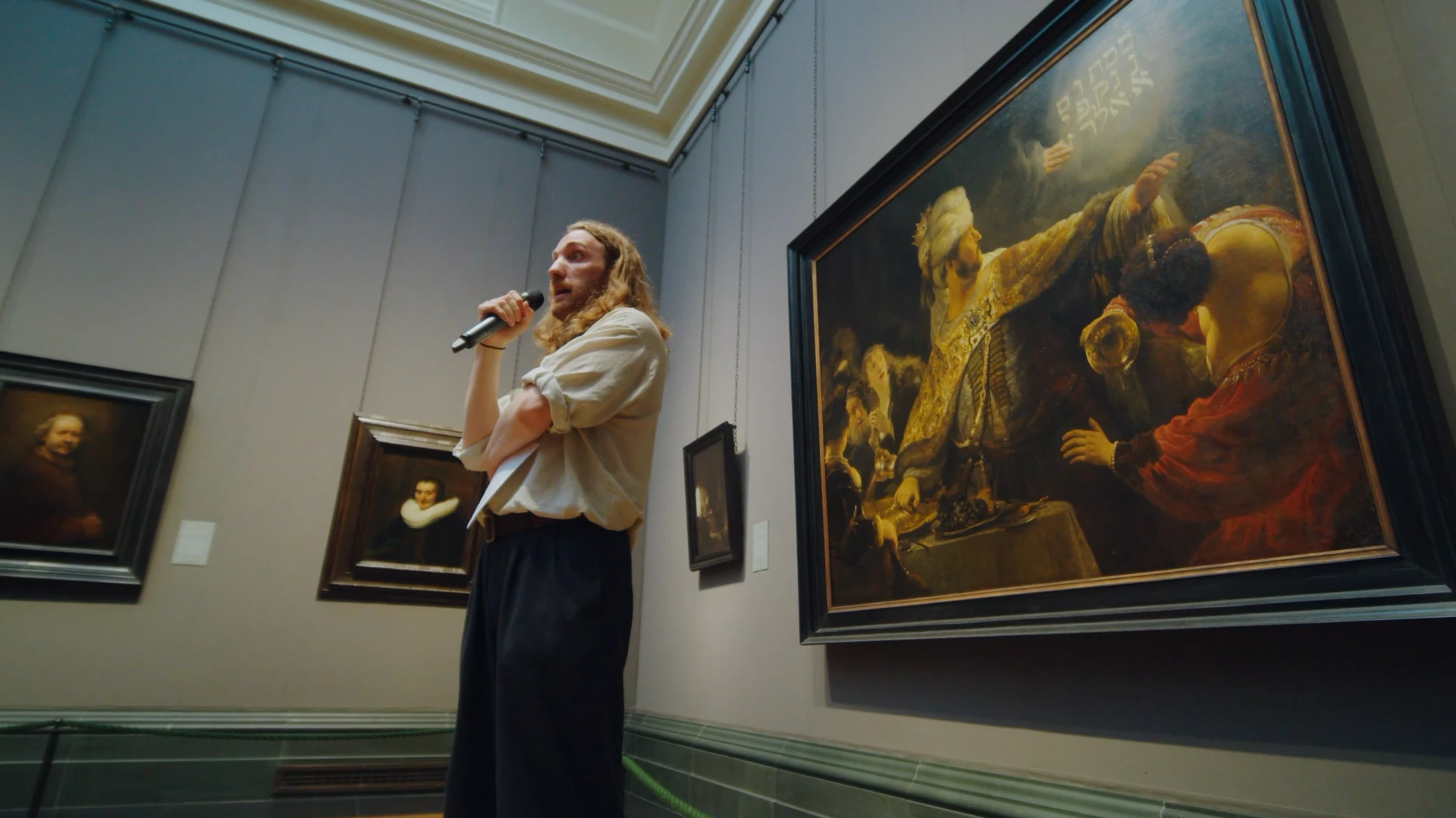 Siris Hill speaking beside Rembrandt&rsquo;s Belshazzar&rsquo;s Feast in the Rembrandt Room